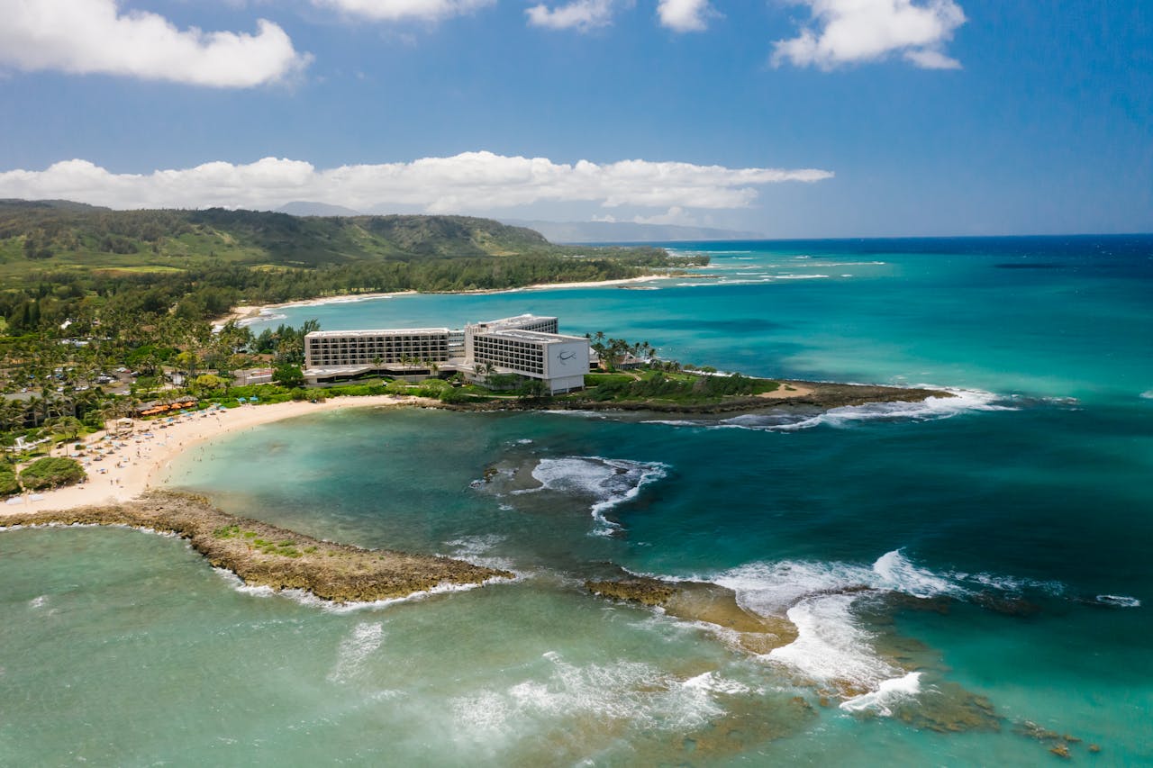 Stunning aerial view of Turtle Bay Resort on the Hawaiian coast, showcasing the lush landscape and turquoise ocean.